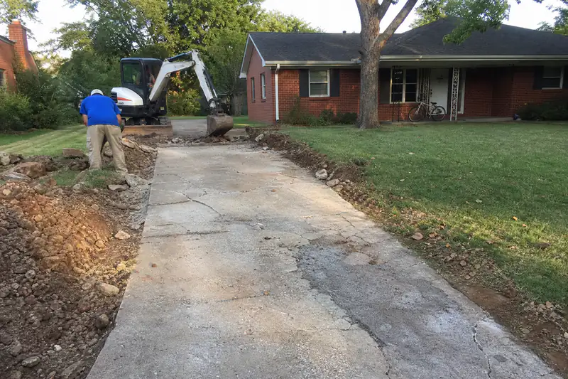 Sixty-year-old cracked concrete driveway at a 1960s ranch house in central Norman, Oklahoma