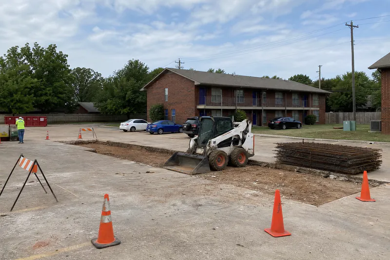 Concrete panel replacement in a small apartment parking lot in Oklahoma City, area coned off