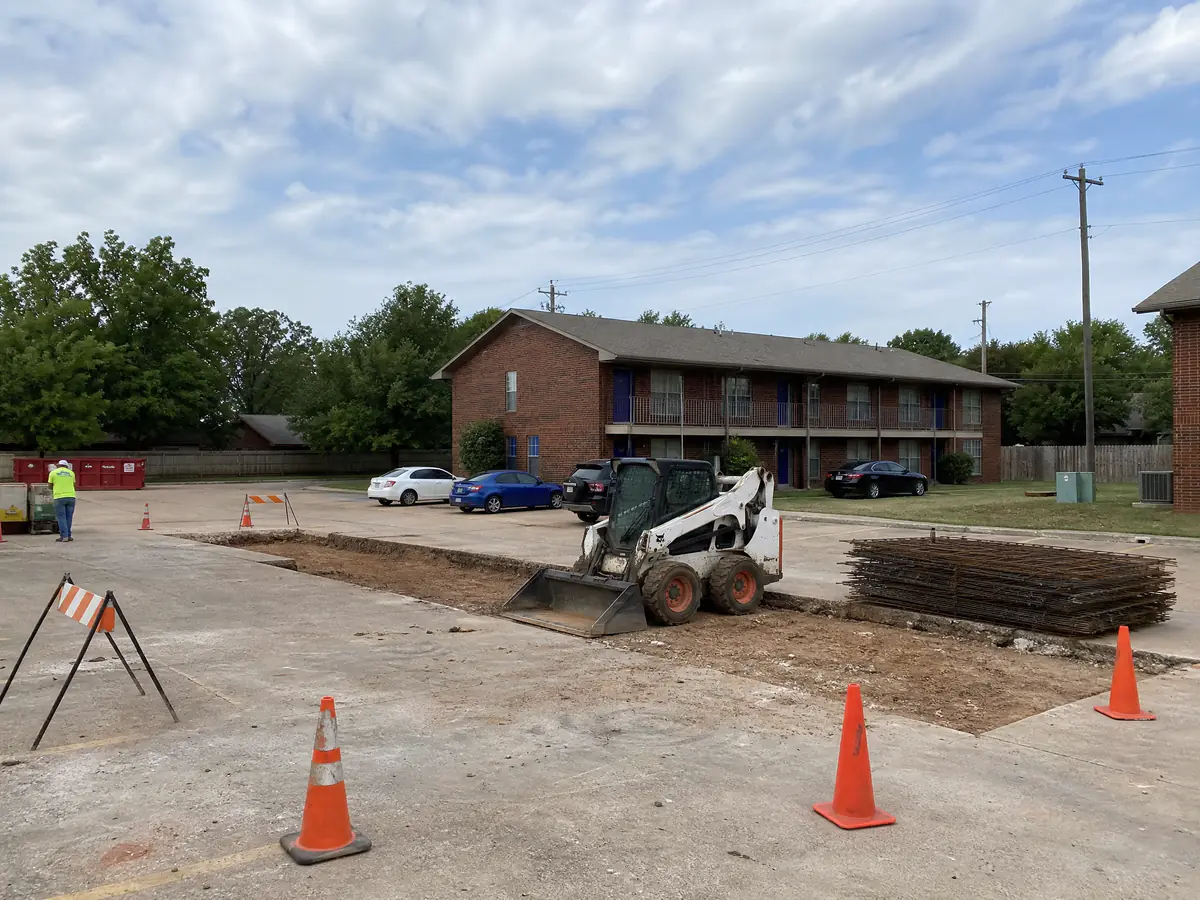 Concrete panel replacement in a small apartment parking lot in Oklahoma City, area coned off