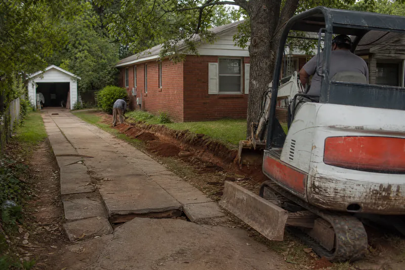 Cracked concrete driveway at a 1940s brick cottage in Bethany, Oklahoma