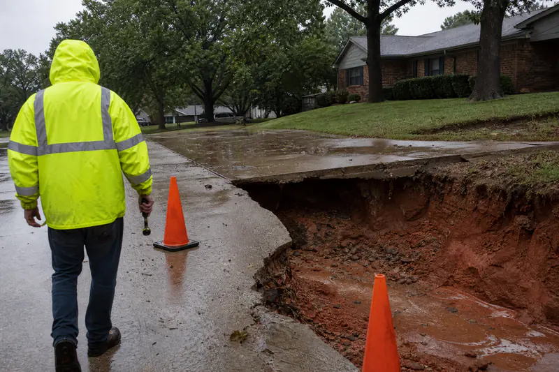 Driveway edge undermined and collapsed after a storm washout at an Oklahoma City home