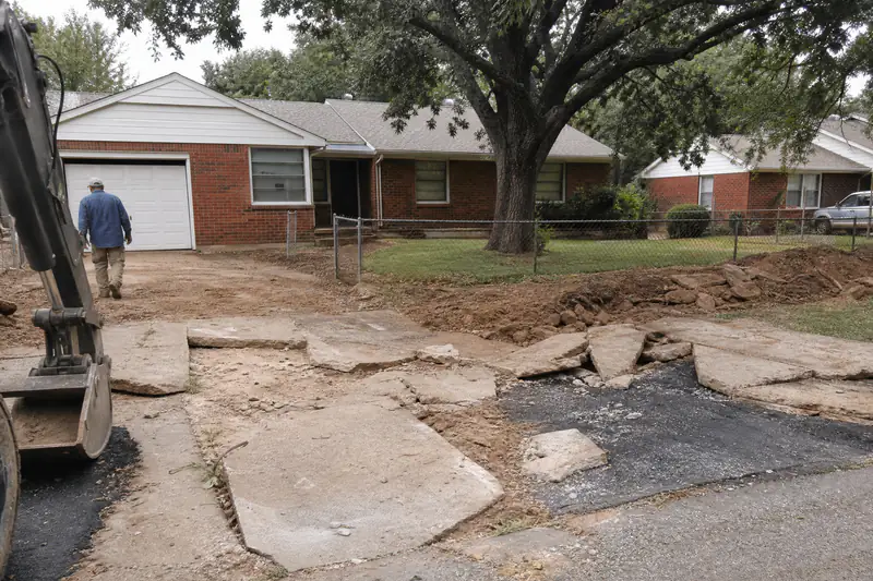 End-of-life 1950s concrete driveway at a small brick home in Del City, Oklahoma